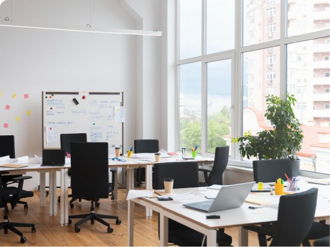 Bright office with desks and whiteboard