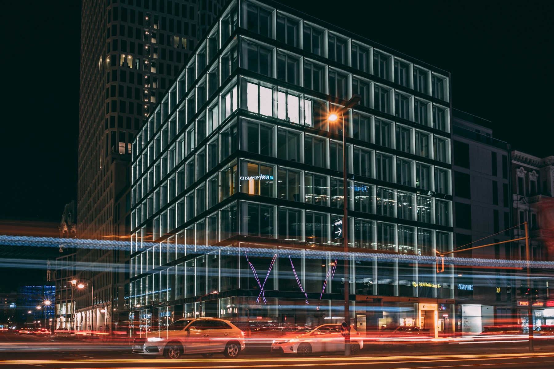 Berlin glass office building illuminated at night